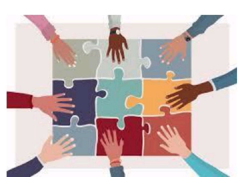 Diverse hands of different skin tones reaching toward a colorful puzzle, symbolizing teamwork, unity, and collaboration